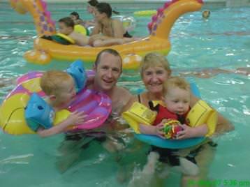 Families enjoying a pool inflatable session